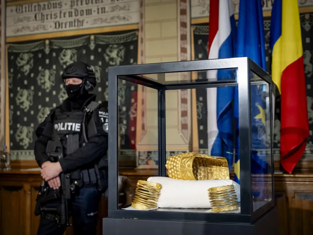 The recovered golden helmet of Cotofenesti and two gold bracelets that were stolen from the Drents Museum are displayed in a glass box in Assen on April 2, 2026. Sem van der Wal / ANP/AFP via Getty Images