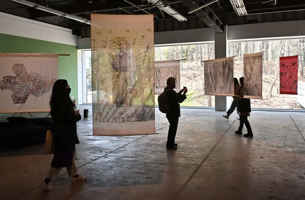 This picture taken on March 31, 2021 shows visitors looking at the art installation 